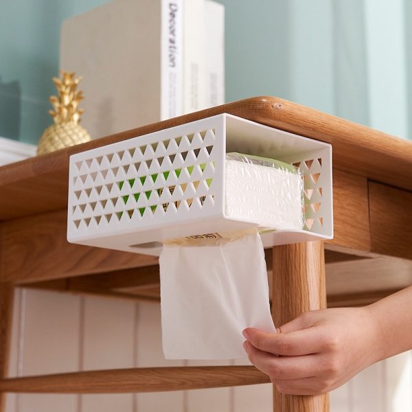 Ondersteunend tissue-opbergsysteem onder houten tafel met geometrisch design voor handige toegang.
