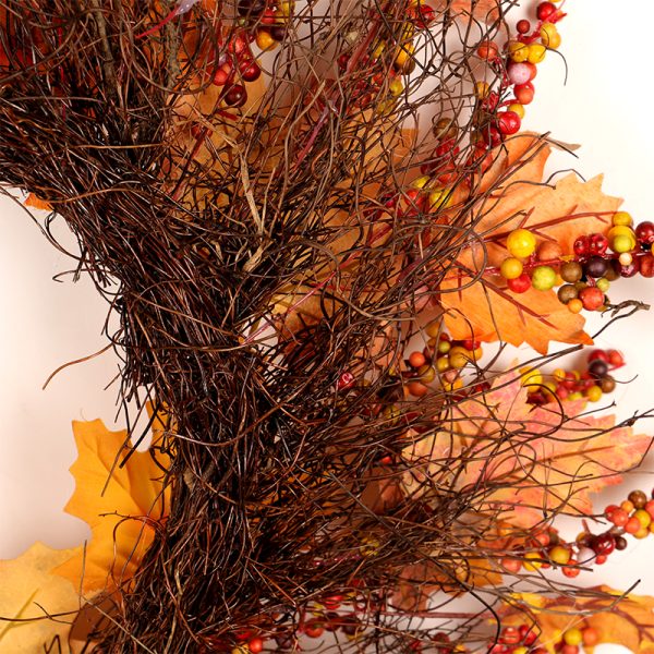 Herfstkrans met kleurrijk blad en bessen, ideaal voor seizoenale decoratie en warme herfststijl in huis.