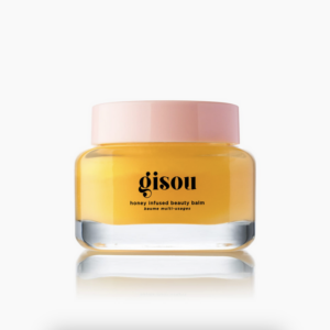 Gele Gisou honey infused beauty balm in een glazen pot met roze deksel, ideaal voor huidverzorging en hydratatie.
