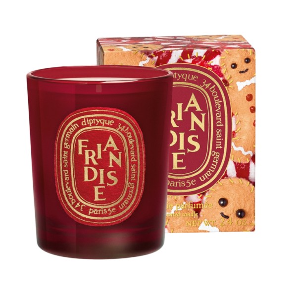 Rode Diptyque geurkaars in luxe verpakking met een kerstthema, ideaal voor feestelijke geuraccenten thuis.