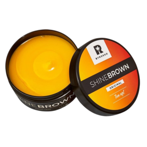 Zonnebrand crème Shine Brown Byrokko open pot met geel product en deksel, ideaal voor een stralende bruine teint.