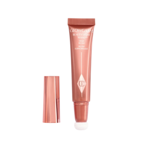 Roze blush tube met applicator en dop naast elkaar, ideaal voor een natuurlijke gloed op de huid.